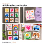 Minigallery magnets with children's drawings in neat rows on a fridge and laid out on a kitchen table