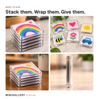 Stacks of Minigallery magnets and a set laid out on a counter, ready to wrap as a gift